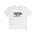 White short-sleeve baby tee with black text reading “My intrusive thoughts sound like this” and a graphic musical note print below.