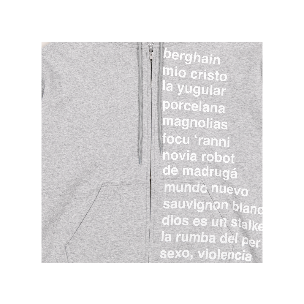 Close-up view of a grey zip-up hoodie, showing a white “LUX” tracklist-style text design printed on the front, with the zipper visible at the center.