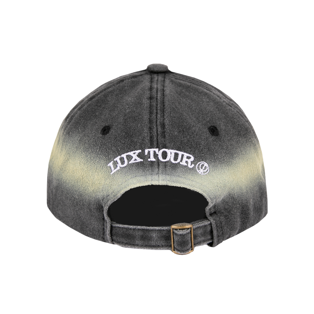 Back view of an ombre gray (halo) and black cap with white LUX TOUR text across the back